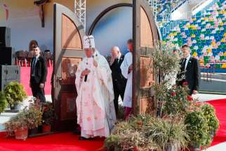  Pope Francis walks through a Holy Door as he arrives to celebrate Mass at Mikheil Meskhi Stadium in Tbilisi, Georgia, Oct. 1.