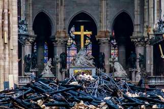 Debris surrounds a depiction of the Pieta by Nicolas Coustou in Notre Dame Cathedral April 16, 2019, a day after a fire destroyed much of the church&#039;s wooden structure. Officials were investigating the cause of the blaze, but suspected it was linked to renovation work that started in January.