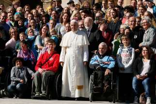 Pope Francis poses with people during his general audience in St. Peter&#039;s Square at the Vatican Oct. 12. Pope Francis told thousands of grandparents in a belated celebration of Italy’s Grandparents’ Day Oct. 15 that they must uphold values that bring hope and wisdom to younger generations.