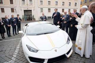 Pope Francis blesses his new Lamborghini Huracan in the presence of top executives from the luxury Italian sports car brand on Nov. 15 at the St. Martha guest house.