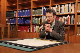 UBC history professor Richard Pollard studies a papal bull that was issued by Pope Innocent IV and 13 cardinals in Lyons in 1245. The parchment is now stored in a vault at the university.