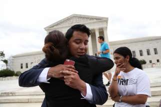 Advocates for immigration reform react June 23 outside the U.S. Supreme Court in Washington after the justices issued a 4-4 split ruling on President Barack Obama&#039;s executive actions on immigration, leaving in place a lower court ruling that blocked Obama&#039;s policies