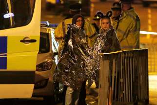 Two women wrapped in thermal blankets stand near Manchester Arena in England where U.S. singer Ariana Grande had been performing May 22. At least 22 people, including children, were killed and dozens wounded after an explosion at the concert venue. Authorities said it was Britain&#039;s deadliest case of terrorism since 2005.