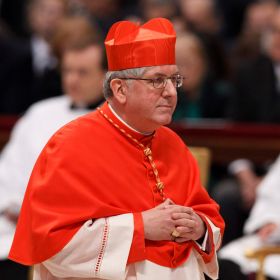 Cardinal Thomas C. Collins of Toronto walks in St. Peter's Basilica after being receiving his red hat from Pope Benedict XVI during a consistory at the Vatican Feb. 18.