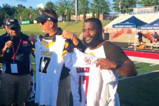 Douglas coach Willis May, left, and St. Matthews Tigers coach Jean Guillaume exchange school jerseys with number 17 to commemorate the 17 victims of the Stoneman Douglas high school shooting. 