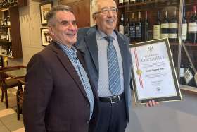 Biagio Vinci, right, with one of his regular clients and his Order of Ontario at his downtown Toronto restaurant.