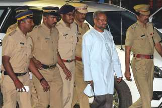 Bishop Franco Mulakkal of Jalandhar, India, is led away for questioning by police Sept. 21 on the outskirts of Cochin. A state court in southern India has denied bail to Bishop Mulakkal who is accused of raping a nun on grounds that he could influence witnesses if released from jail. 