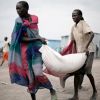 South Sudanese who fled recent ethnic violence carry food aid from a World Food Program distribution center in Pibor, South Sudan, Jan. 12. The outbreak of violence in Jonglei state, which began in late December, has led to a &quot;new cycle of revenge and re taliation,&quot; Sudan&#039;s Council of Churches said.