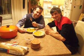 Ryan Worms and Luke Stocking are enjoying a piece of bread and a bowl of soup together.
