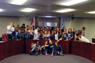 Roy Fernandes (wearing tie) joins St. Sylvester students having some fun with Toronto councillor Jim Karygiannis during a trip to City Hall. 