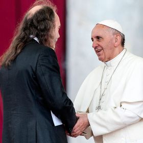 Pope Francis greets Irish writer John Waters during a Pentecost prayer vigil in St. Peter's Square at the Vatican May 18. An estimated 200,000 people from 150 Catholic lay movements attended the vigil.