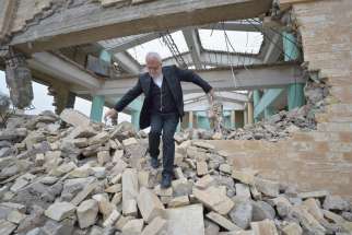 Father Emanuel Youkhana, an archimandrite of the Assyrian Church of the East, walks through the rubble of a demolished church in Mosul, Iraq, Jan. 27.