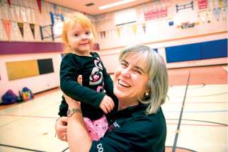 Linda Ward gives little Alessia Mussol a boost at the end of another Monday night of Special Olympics activities in the gym of St. Brigid’s Catholic School.