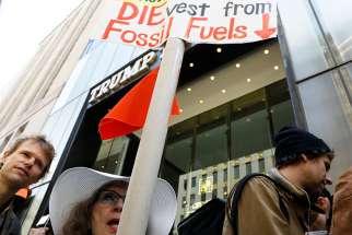 Protesters gather for a fossil fuel and climate change protest outside Trump Tower May 9 in New York City.