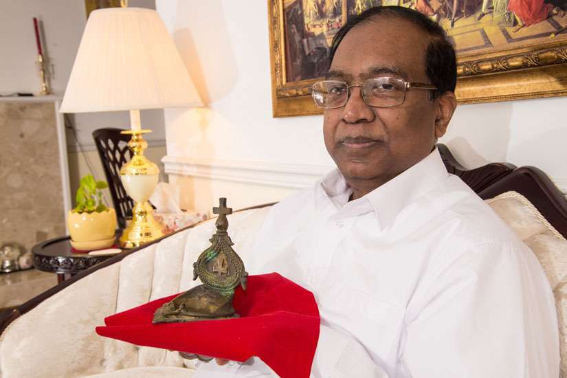 Fr. Joseph Chandrakanthan holds a 16th-century lamp believed to have been used by St. Joseph Vaz in Sillalai, Sri Lanka.