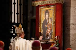 Pope Francis touches a Marian image after leading Benediction outside the Basilica of St. Mary Major on the feast of Corpus Christi in Rome May 26.