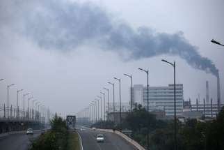 Smoke billows out of factory chimneys Oct. 1 on the outskirts of Delhi, India. Members of the European Parliament voted in favor of the Paris U.N. COP 21 climate change agreement Oct. 4 at a plenary meeting in Strasbourg, France.