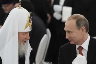 Russian President Vladimir Putin, right, listens to Russian Orthodox Patriarch Kirill of Moscow during a reception commemorating the 1,000th anniversary of the death of Grand Prince Vladimir I (Vladimir the Great), at the Kremlin in Moscow in this July 28, 2015, file photo. Church leaders have appealed to Patriarch Kirill to intervene and ask President Putin to stop the bloodshed in Ukraine.