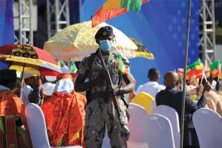 An Ethiopian police officer stands guard during a pro-government rally in Addis Ababa Nov. 7. People were denouncing what rally organizers say is interference by the Tigray People’s Liberation Front and Western countries in internal affairs of the country.