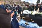 Relatives and friends of a miner mourn near his casket Aug. 25 after he was killed during clashes with police in Sayari, Bolivia. Large-scale mining and extractives operations are failing to deliver economic benefits while causing environmental damages and human suffering throughout Latin America, said a coalition of church organizations and environmental groups.