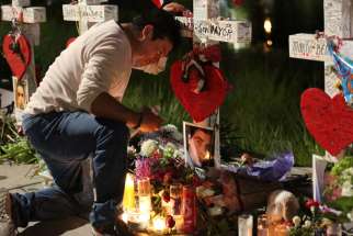 Jose Louis Morales cries as he kneels June 21 at a makeshift memorial for his brother Edward Sotomayor Jr. and other victims of the Pulse night club shootings in Orlando, Fla. Msgr. Stephen Rossetti, a Washington-based licensed psychologist, plans to conduct a free webinar in late August to prepare priests, religious and other church members how to deal with the trauma that follows large-scale tragedies.