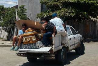 Relatives carry the coffin of a relative on a vehicle in Pedernales, Ecuador, April 17, after an earthquake struck the previous day off the country&#039;s Pacific coast. At least 272 people died, nearly 3,000 were injured and thousands were left homeless in the magnitude-7.8 earthquake.