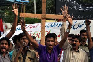 Pakistani members of the Christian minority shout slogans during a Nov. 9 protest in Karachi, Pakistan, against the killing of a Christian couple accused of blasphemy. The Catholic Church in Pakistan has presented a series of demands to the government, c alling for a fair and thorough investigation into the beatings and burning of the young Christian couple accused of desecrating the Quran.