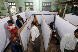 People check their names on final voter list displayed at a polling station in Mandalay, Myanmar, Nov. 1. Myanmar will hold its nationwide general elections Nov. 8.