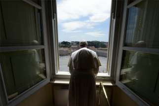 Pope Francis looks out on an empty St. Peter&#039;s Square after leading the &quot;Regina Coeli&quot; prayer from his library in the Apostolic Palace at the Vatican May 10, 2020. The Sunday prayer took place without the physical presence of the faithful due to the coronavirus pandemic.