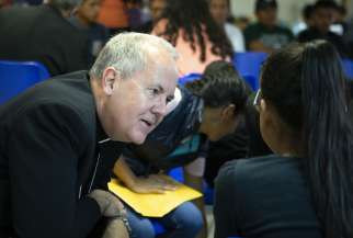 Bishop Joseph C. Bambera of Scranton, Pa., talks to an immigrant woman, recently released from U.S. custody, July 1, at a Catholic Charities-run respite centre in McAllen, Texas. A delegation of U.S. bishops has traveled to the Diocese of Brownsville, Texas, to learn more about the detention of Central American immigrants at the U.S.-Mexican border. 