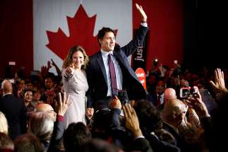 Liberal Party leader winner Justin Trudeau and his wife Sophie Gregoire wave during victory speech in Montreal, Oct. 19, 2015.