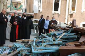 Cardinal Pietro Parolin, Vatican secretary of state, with red sash, views the damage at Sacred Heart School near Beirut&#039;s port area Sept. 4, 2020, one month after the city suffered double blasts.