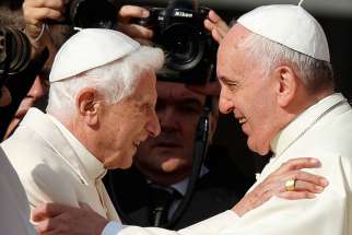 Pope Francis greets emeritus Pope Benedict XVI during an encounter for the elderly in St. Peter&#039;s Square at the Vatican Sept. 28.