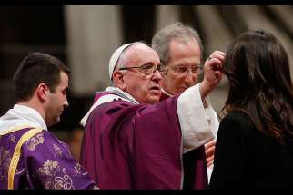  Pope Francis gives ashes to a woman as he celebrates Ash Wednesday Mass in St. Peter&#039;s Basilica at the Vatican Feb. 10.