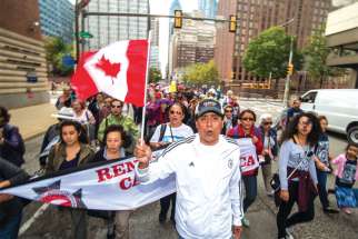 Members of the Charismatic Renewal movement from the Greater Toronto Area fly the Canadian flag in downtown Philadelphia on their way to Mass with Pope Francis on Sept. 27.