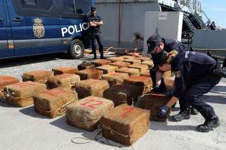 Spanish national police officers unload bales of seized drugs in Las Palmas, on the Canary island of Gran Canaria, Spain, Oct. 23. Pope Francis said illegal drug makers and dealers are traffickers of death and must be stopped. 