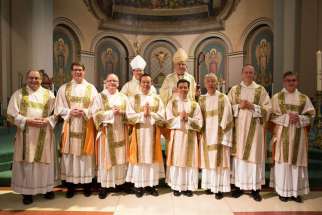 Cardinal Thomas Collins and Bishop Vincent Nguyen join the eight new deacons for the Archdiocese of Toronto for a photo May 24. The deacons are, from left, Timothy Dunlop, John Brown, Delbert Allan, Paul Ma, Raphael Sumabat, Peter Takaoka, Stephan Brunck and Richard Te.