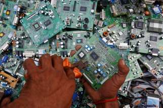 A man in Karachi, Pakistan, retrieves circuit boards from discarded computer monitors Aug. 16, 2017. An economic system lacking any ethics leads to a &quot;throwaway&quot; culture of consumption and waste, Pope Francis said in a speech addressed to members of the Council for Inclusive Capitalism during an audience at the Vatican Nov. 11.