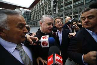 Father John O&#039;Reilly, center, of the Legionaries of Christ arrives at a court in Santiago, Chile, Oct. 15. The court found Father O&#039;Reilly, who moved to Chile from Ireland in 1985, guilty of sexually abusing a pre-teen girl at the private Colegio Cumbres in the affluent neighborhood of Las Condes between 2007 and 2009.
