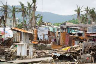 This photo taken Feb. 10, 2014 from the home of Emmanuel and Maria Rosevilla Margate shows homes left in ruins in Tacloban, Philippines. The family huddled together in their block home Nov. 8, 2013, as Typhoon Haiyan made shambles of many homes in their community.