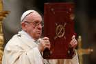 Pope Francis raises the Book of the Gospels during a Mass marking the feast of the Epiphany in St. Peter&#039;s Basilica at the Vatican Jan. 6.