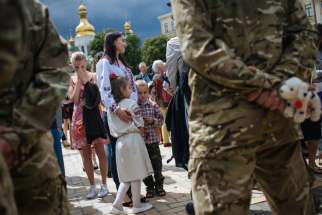 Relatives and friends attend an allegiance ceremony of a Ukrainian army battalion in Kiev before they depart to eastern Ukraine June 23. The Ukrainian Catholic Church welcomed government plans to restore military chaplains to boost soldiers&#039; morale in th e struggle with pro-Russia rebels in eastern Ukraine.