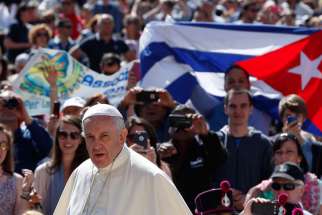 A man holds Cuba&#039;s flag in the crowd as Pope Francis arrives to lead his general audience in St. Peter&#039;s Square at the Vatican in this photo dated May 27, 2015. Bishop Wilfredo Pino Estevez said that Pope Francis’ visit to Cuba is a sign of his closeness to the nation&#039;s people at a time they &quot;breathe the air of hope&quot; that relations with the United States will improve