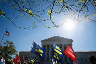 Supporters for same-sex marriage stand outside the U.S. Supreme Court in Washington April 28.The high court began hearing arguments in cases involving four states that bar same-sex marriage.