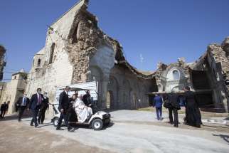 Pope Francis arrives in a golf cart to visit the destroyed Al-Tahera Syriac Catholic Church in Mosul, Iraq, March 7, 2021. Christians have been fleeing Iraq due to persecution.
