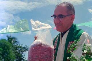 Then-Archbishop Oscar Romero receives a sack of beans from parishioners following Mass outside of a church in San Antonio Los Ranchos in Chalatenango, El Salvador, in 1979. Dominican Father Gustavo Gutierrez, considered by many as the father of liberation theology, said he supports an effort to declare now-St. Oscar Romero a doctor of the Catholic Church.