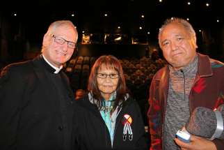 Father Larry Lynn smiles next to residential school survivor Monique Sabourin and Steven Point, former lieutenant governor of British Columbia, after the world premiere of Father Lynn&#039;s documentary, &quot;In the Spirit of Reconciliation,&quot; in Vancouver Dec. 6.