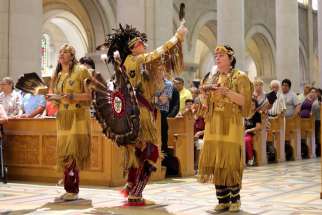 Members of the Huron-Wendat Nation perform a purification ritual at the Basilica of Sainte Anne-de-Beaupre in Quebec June 26.