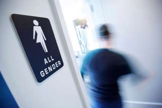 A bathroom sign welcomes both genders at the Cacao Cinnamon coffee shop in Durham, N.C., on May 3, 2016.