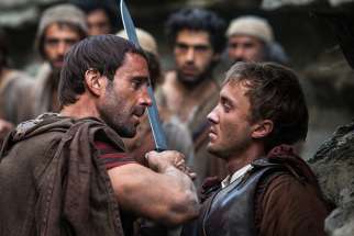 Joseph Fiennes and Tom Felton star in a scene from the movie &quot;Risen.&quot; The Catholic News Service classification is A-III -- adults. The Motion Picture Association of America rating is PG-13 -- parents strongly cautioned. Some material may be inappropriate for children under 13.